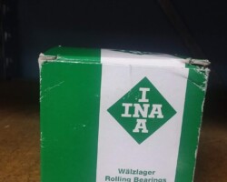 A box with a green label on it sits on a shelf.