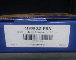 A box with a label on it is sitting on a shelf.